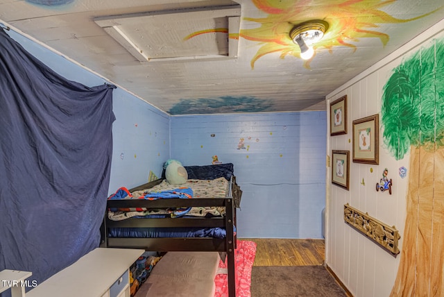 bedroom with wood walls, ceiling fan, and dark wood-type flooring