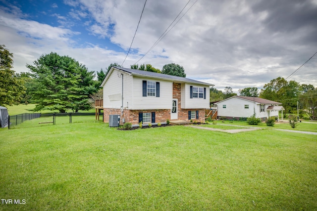 bi-level home featuring a front yard and central air condition unit