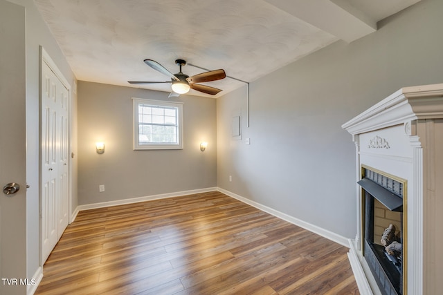 unfurnished living room with ceiling fan and hardwood / wood-style flooring