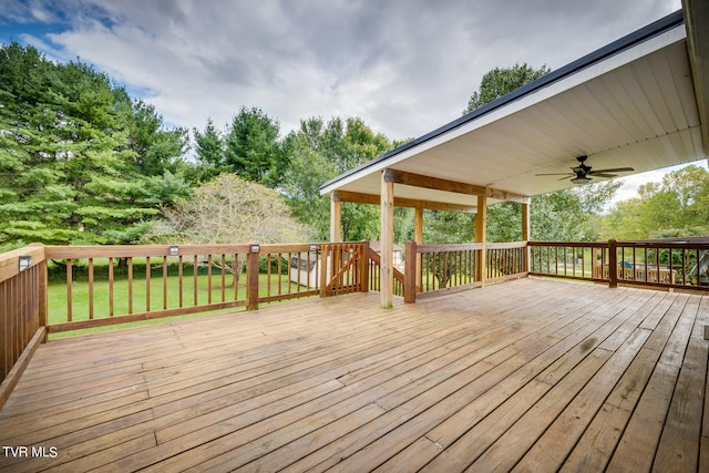 wooden terrace with a lawn and ceiling fan