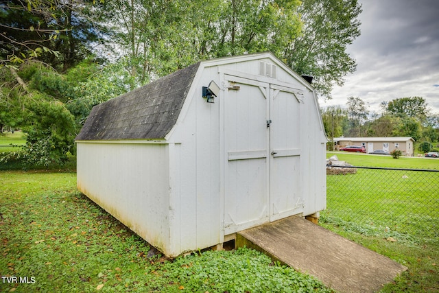 view of outbuilding with a yard