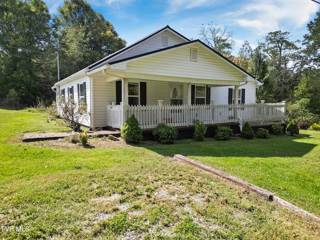 view of front of house featuring a front yard and a wooden deck