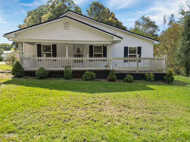 single story home featuring a front yard and a deck