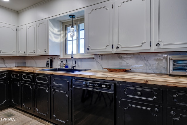 kitchen featuring dishwasher, white cabinets, sink, and wood counters