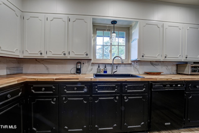 kitchen featuring white cabinets, hanging light fixtures, sink, ornamental molding, and dishwasher