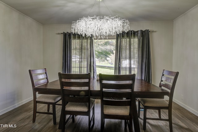 dining space with an inviting chandelier, ornamental molding, and dark hardwood / wood-style flooring