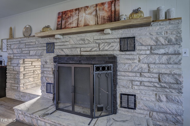 interior details with ornamental molding, wood finished floors, and visible vents