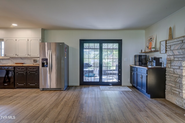 kitchen featuring stainless steel refrigerator with ice dispenser, light hardwood / wood-style floors, white cabinetry, and black dishwasher