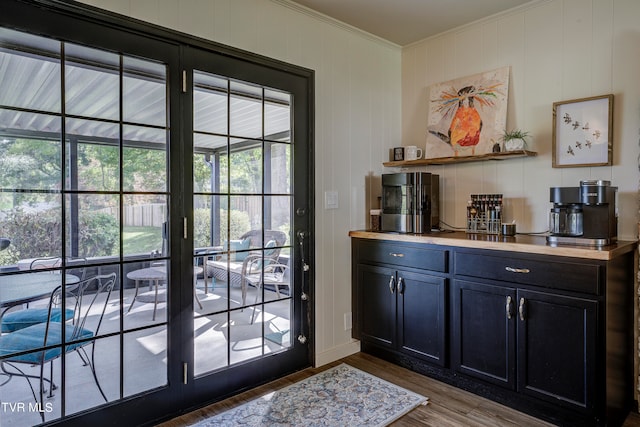 doorway to outside with crown molding and dark hardwood / wood-style flooring