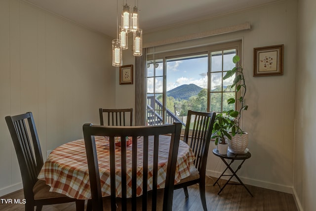 dining space featuring crown molding, a mountain view, and dark hardwood / wood-style floors