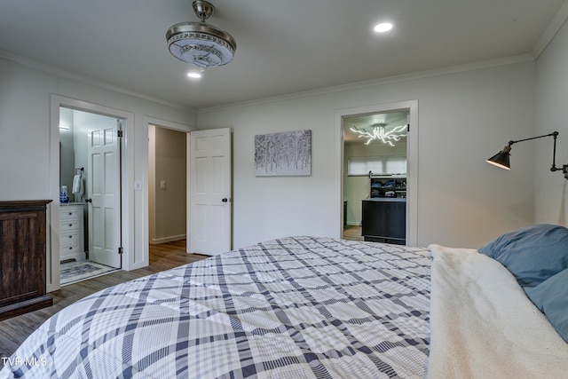 bedroom with a spacious closet, a closet, connected bathroom, dark hardwood / wood-style flooring, and ornamental molding