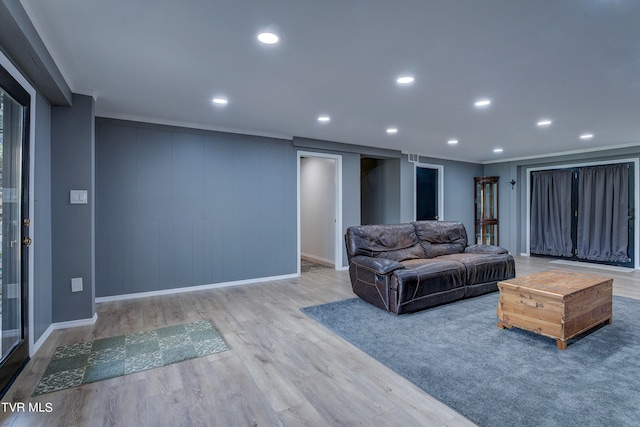 living room with crown molding and hardwood / wood-style flooring