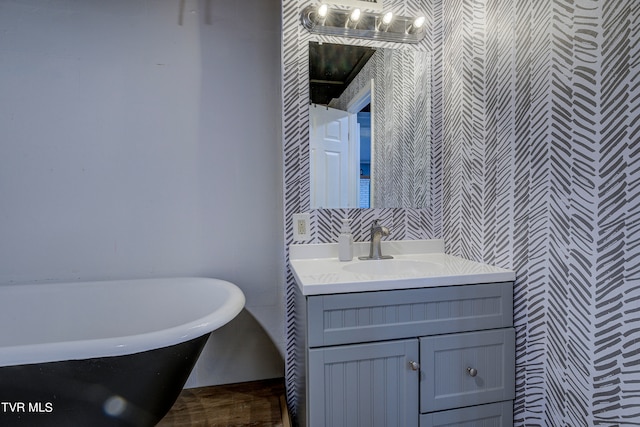 bathroom featuring a tub to relax in and vanity