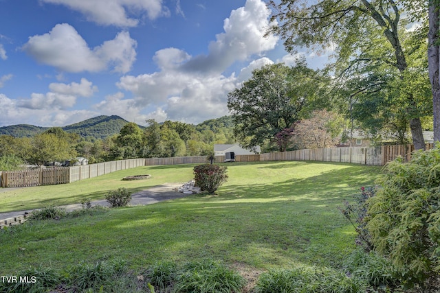 view of yard featuring a fenced backyard and a mountain view