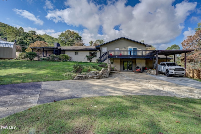 view of front of property with a front lawn, a wooden deck, and a carport