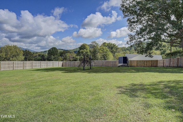 view of yard featuring a fenced backyard and a mountain view