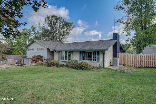 ranch-style home with cooling unit and a front yard