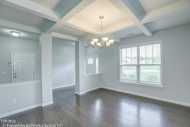 empty room with coffered ceiling, beamed ceiling, dark wood-type flooring, and a chandelier