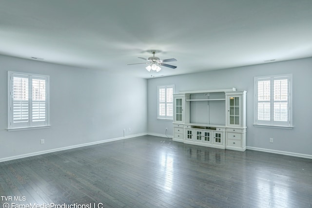 unfurnished living room featuring dark hardwood / wood-style flooring and ceiling fan