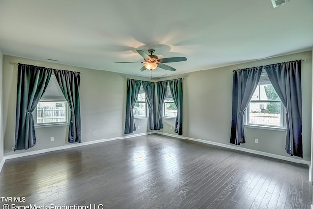 unfurnished room with ceiling fan, plenty of natural light, and dark hardwood / wood-style flooring