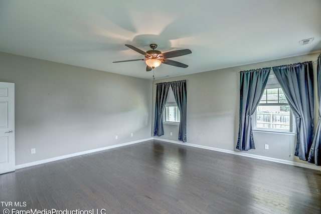 empty room featuring ceiling fan and dark hardwood / wood-style floors