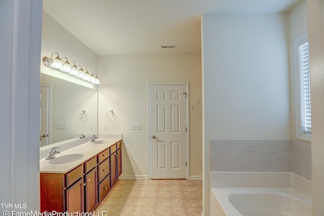 bathroom featuring a tub to relax in and vanity