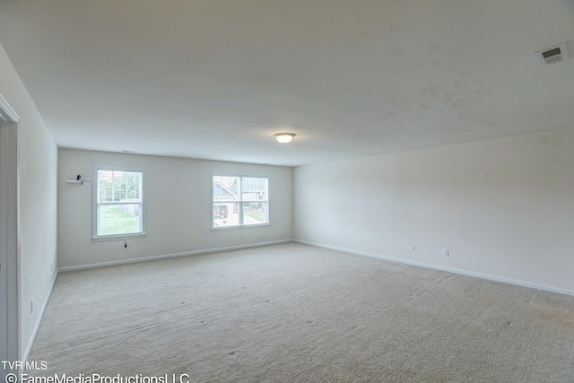 unfurnished room featuring light colored carpet