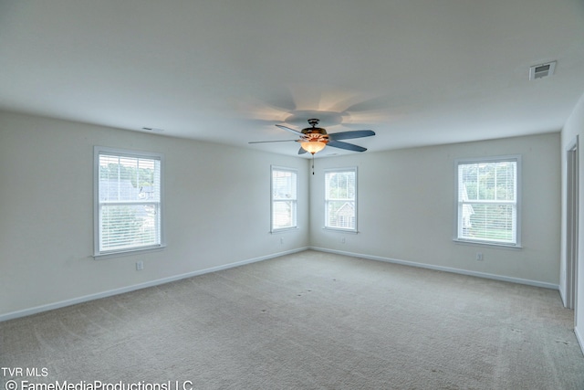 carpeted spare room with ceiling fan