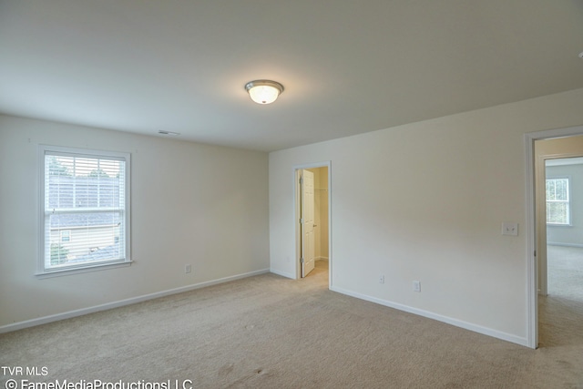 unfurnished room with light colored carpet