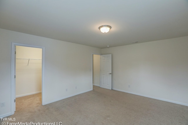 unfurnished room featuring light colored carpet