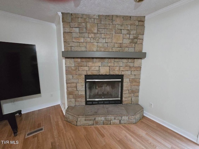 room details with hardwood / wood-style floors, a textured ceiling, and crown molding