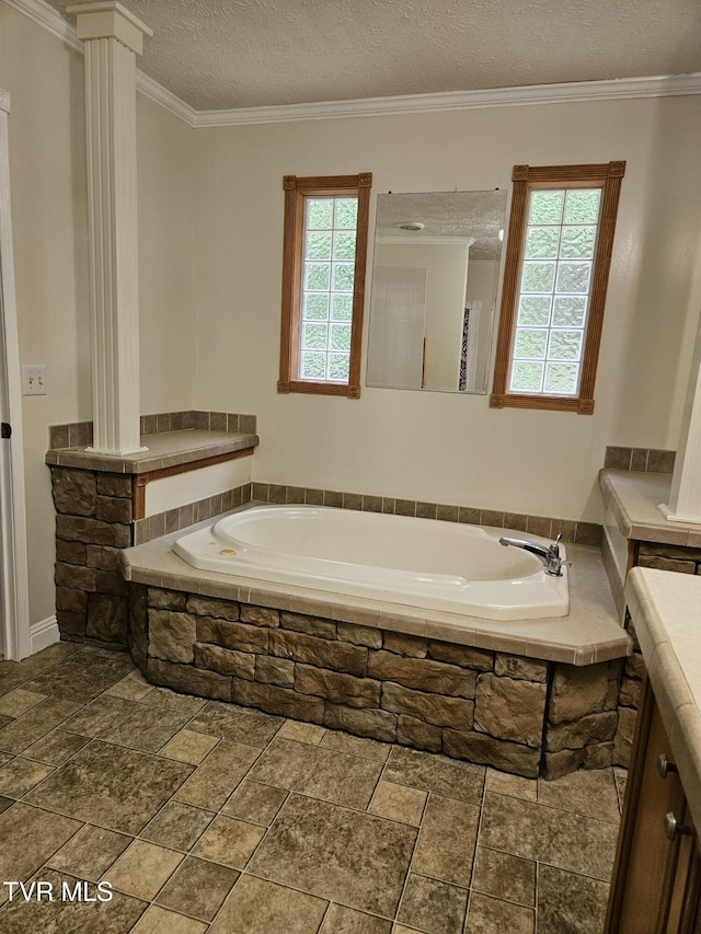 bathroom featuring ornate columns, plenty of natural light, a textured ceiling, and crown molding