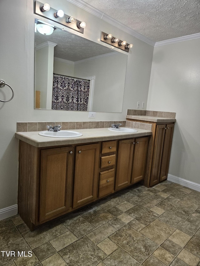 bathroom featuring ornamental molding, vanity, and a textured ceiling