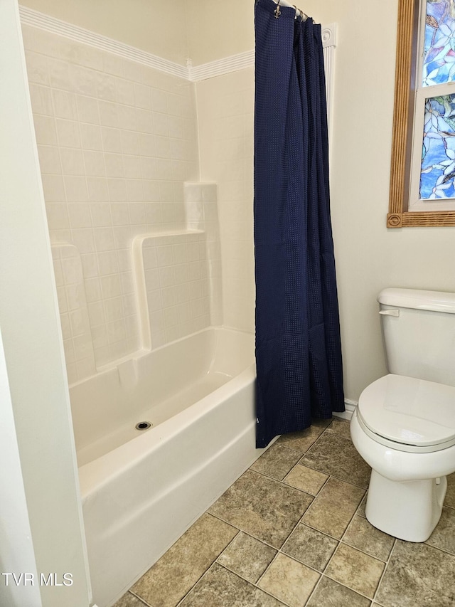 bathroom featuring toilet, ornamental molding, and shower / bathtub combination with curtain