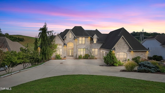 french country home featuring a yard