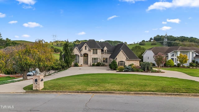 french country style house featuring a front lawn