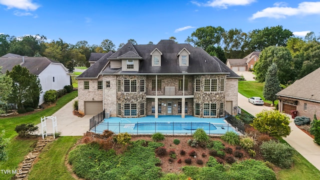 back of property featuring a garage, a patio, and a balcony