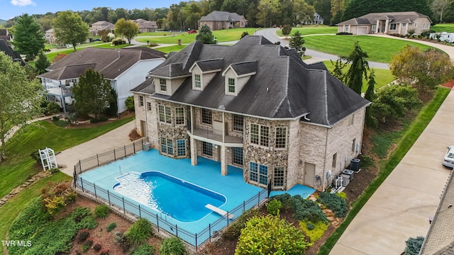 view of pool with a lawn, central AC unit, a diving board, and a patio area