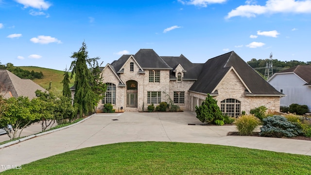 french country home with a front lawn