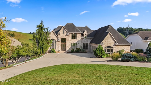 french country style house with a front yard