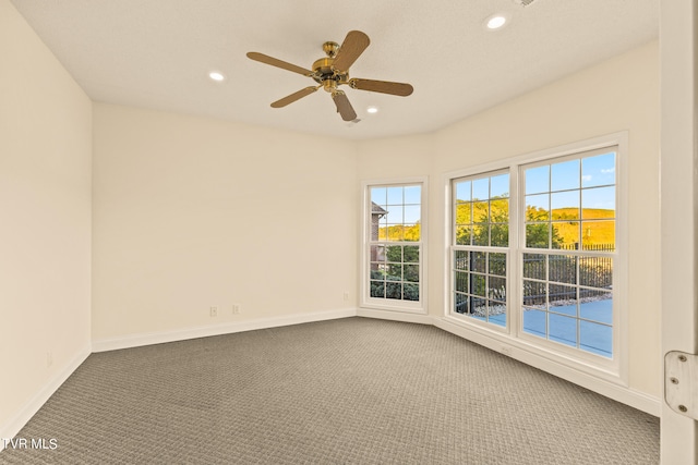 carpeted empty room featuring ceiling fan