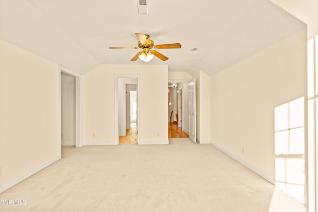 unfurnished room featuring lofted ceiling, light colored carpet, and ceiling fan