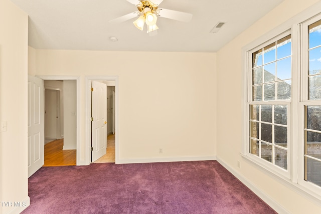 carpeted empty room featuring ceiling fan