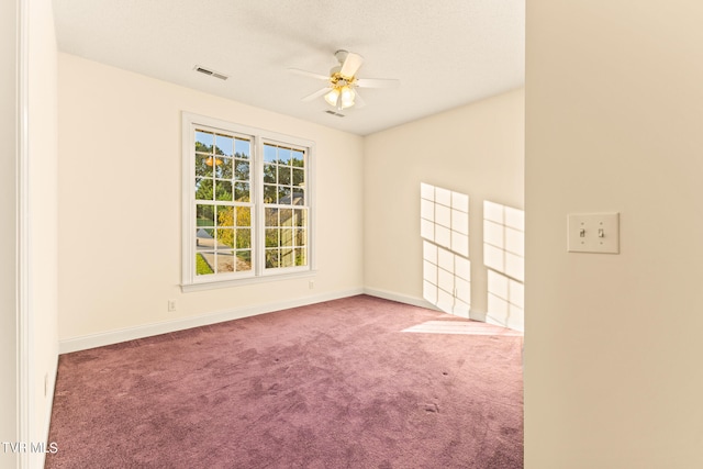 carpeted spare room with ceiling fan