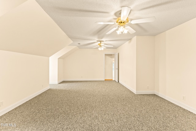 bonus room with vaulted ceiling, carpet, a textured ceiling, and ceiling fan