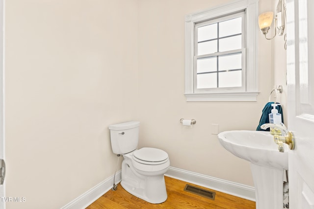 bathroom with sink, hardwood / wood-style flooring, and toilet