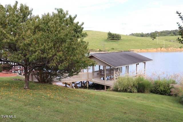 view of dock with a rural view, a lawn, and a deck with water view