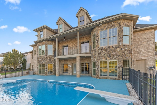 view of swimming pool featuring a diving board