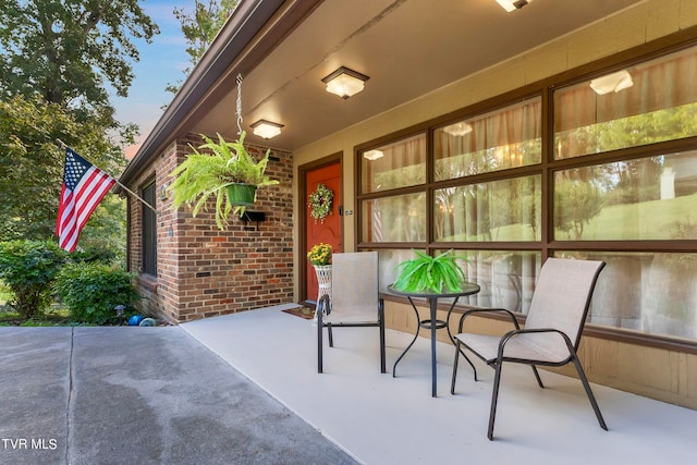 view of exterior entry featuring a patio