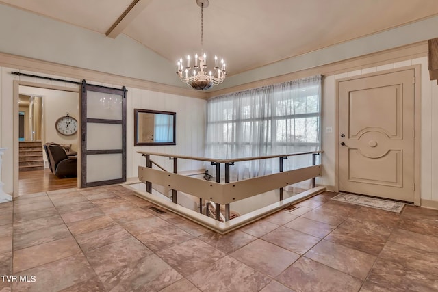 foyer with lofted ceiling with beams, an inviting chandelier, and a barn door